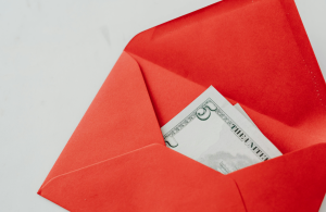 Red Envelope Partially Open Revealing One Hundred Dollar Bill Inside Against Light Solid Background – Sleek Money Concept Like Podcast Summary Cover or YouTube Thumbnail Creatorpoint – Creator Knowledge, Simplified. The best resources, podcast summaries, and learning for creators.