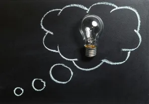 Creative idea and inspiration represented by a light bulb in a chalk-drawn thought bubble on blackboard Creatorpoint – Creator Knowledge, Simplified. The best resources, podcast summaries, and learning for creators.