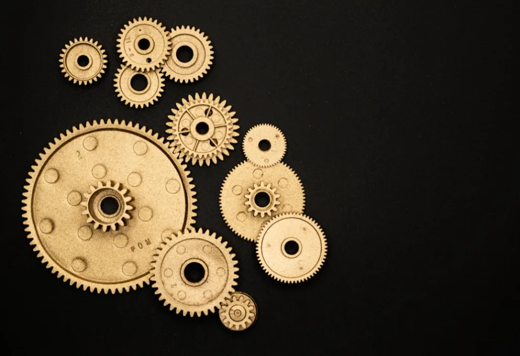 Artistic display of brass gears on black background, visually appealing arrangement with intricate toothed edges, resembling hidden gems. Perfectly illustrates creativity and discovery, similar to finding valuable insights in YouTube tips and tricks tutorials. Creatorpoint – Creator Knowledge, Simplified. The best resources, podcast summaries, and learning for creators.