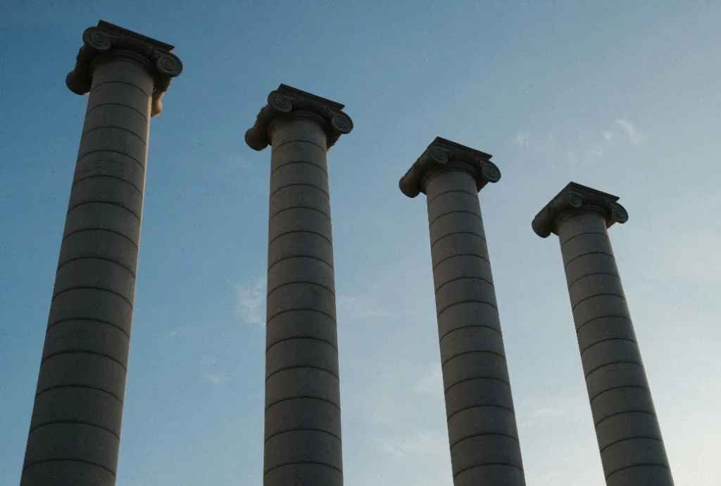 Tall stone columns with Doric capitals symbolizing business success, captured against a clear blue sky. The photo highlights their impressive height and intricate architectural details, resembling solo entrepreneurs reaching for new heights. Ideal representation of ambition and achievement in architecture. Creatorpoint – Creator Knowledge, Simplified. The best resources, podcast summaries, and learning for creators.