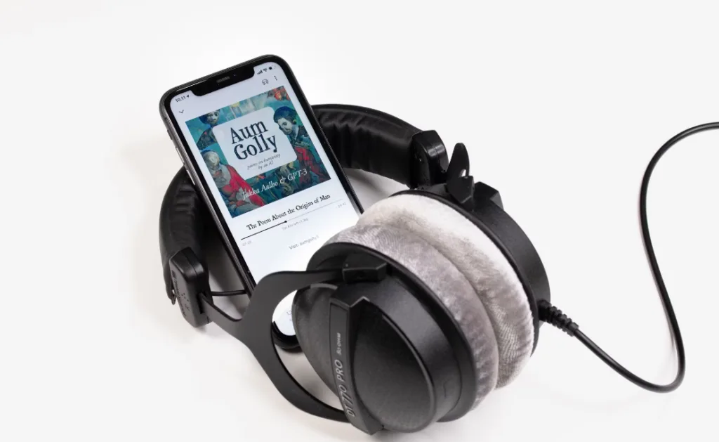 Large black headphones with gray cushioning lay over a smartphone displaying "Aun Golly" audiobook, ready for playback. This setup highlights innovative digital product ideas for revolutionizing storytelling experiences. Perfect concept image for audiobooks and modern tech engagement with stories. Creatorpoint – Creator Knowledge, Simplified. The best resources, podcast summaries, and learning for creators.