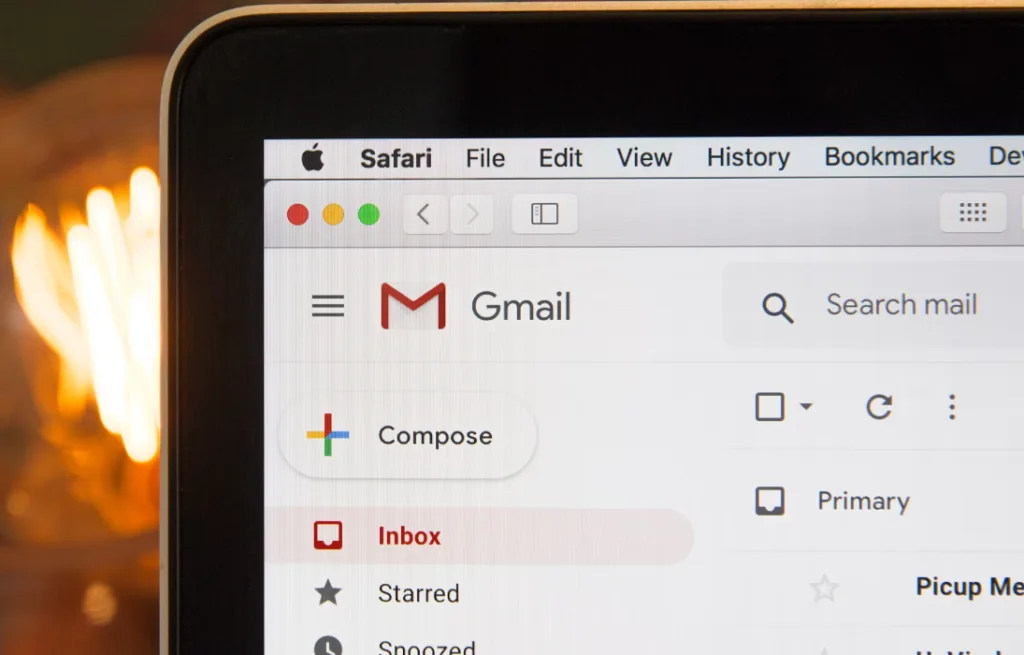 Close-up of Gmail interface on computer screen for brainstorming digital product ideas. Visible features: Compose, Inbox, Starred, Snoozed options on left. Safari browser tab at top. Out-of-focus light bulb symbolizes innovation in the background. Ideal image for tech and creativity-themed content. Creatorpoint – Creator Knowledge, Simplified. The best resources, podcast summaries, and learning for creators.