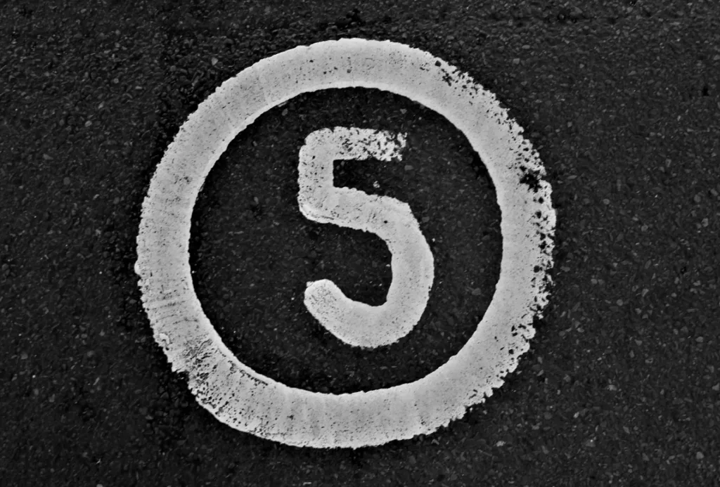 Number 5 painted in white on dark asphalt symbolizes mastering YouTube Shorts engagement, emphasizing quick attention-grabbing techniques for maximizing views. This visual representation guides creators in optimizing content strategies to increase visibility and rankings on YouTube's platform. Creatorpoint – Creator Knowledge, Simplified. The best resources, podcast summaries, and learning for creators.